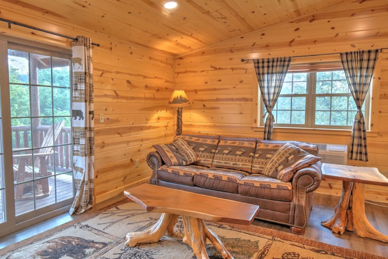 Comfortable sofa and French doors to the balcony in the Barnwood Suite